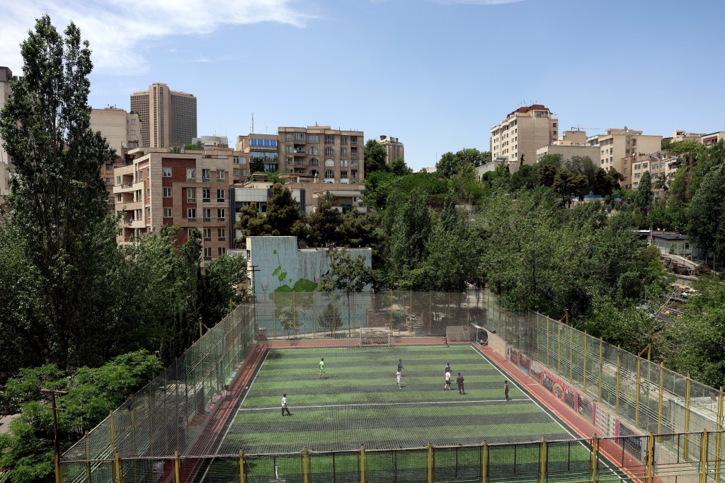 Photo by - / AFP  Iranian children play football among residential buildings in Tehran on May 7, 2026.