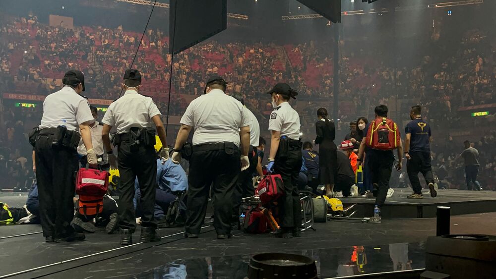 Two dancers receive medical treatment at a concert of Cantopop boy band Mirror, in Hong Kong, Thursday, July 28, 2020. Two dancers were injured at a Cantopop concert in Hong Kong after a massive video screen suspended above the stage fell onto performers below. (Sing TaoPhoto) 