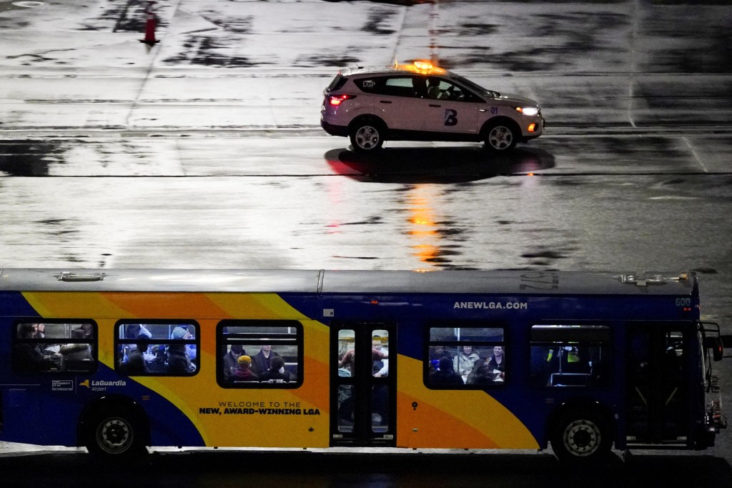 A bus transports plane crash survivors after an Air Canada Express jet collided with a ground vehicle at LaGuardia Airport in Queens, New York, U.S., March 23, 2026. (Reuters)