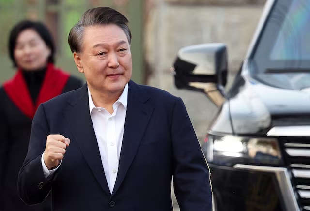 Former South Korean President Yoon Suk Yeol reacts outside the Seoul detention center after his release, in Uiwang, South Korea, March 8, 2025. REUTERS/Kim Hong-ji