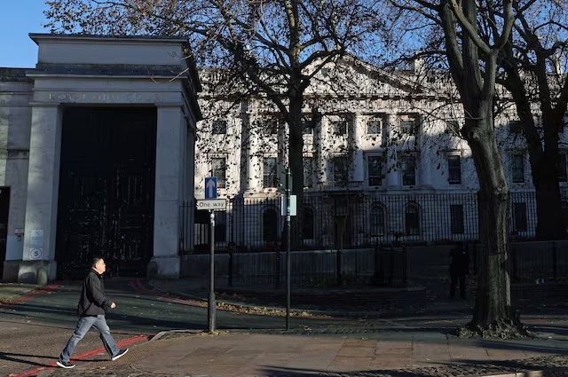 A person walks past Royal Mint Court, the proposed site of the new Chinese embassy, in London, Britain, November 21, 2025. REUTERS/Toby Melville
