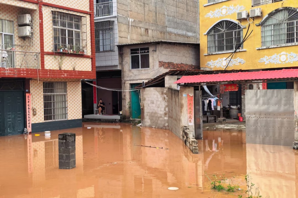 Floodwaters inundate a street lined with residential buildings after heavy rainfall brought by typhoon Narra caused flooding in Ningming county, Chongzuo, Guangxi Zhuang Autonomous Region, China August 24, 2026. cnsphoto via REUTERS