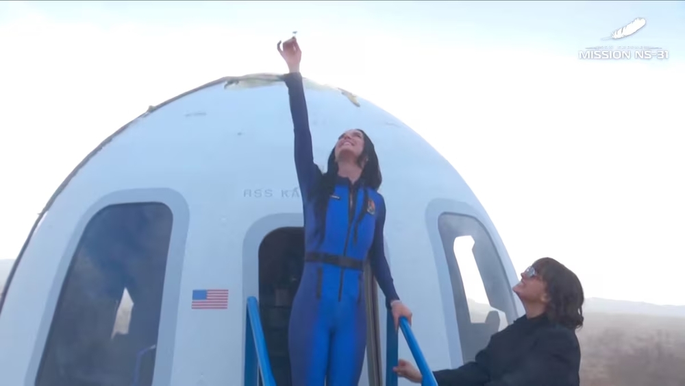 Pop star Katy Perry comes out of the capsule in which she, journalists Gayle King, Lauren Sanchez, who is also billionaire Jeff Bezos' fiance and other participants, landed back on earth after blasting off into space on a Blue Origin rocket. (Reuters)