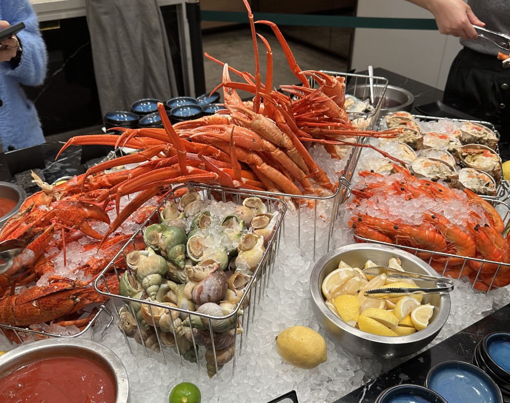Seafood on ice – lobster, snow crab legs, brown crab, scallop, sea whelk, shrimp, mussels.