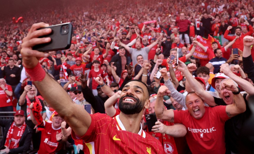 Mohamed Salah takes a selfie with fans after Liverpool won the Premier League last season. REUTERS 