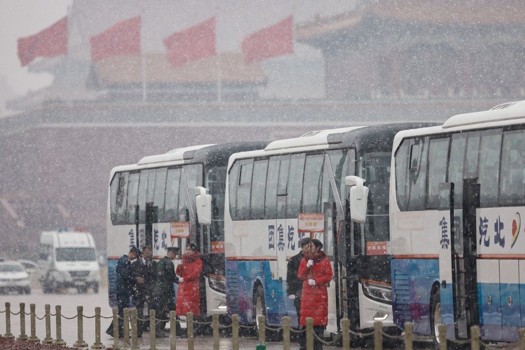 Members of the Chinese People's Liberation Army (PLA) enter a shuttle bus amid snowfall on Tiananmen Square, before the opening session of the Chinese People's Political Consultative Conference (CPPCC), in Beijing, China March 4, 2026. (Reuters)
