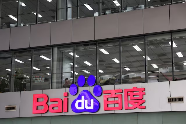 A staff member works near a Baidu logo at its office in Beijing, China March 17, 2026. REUTERS/Florence Lo