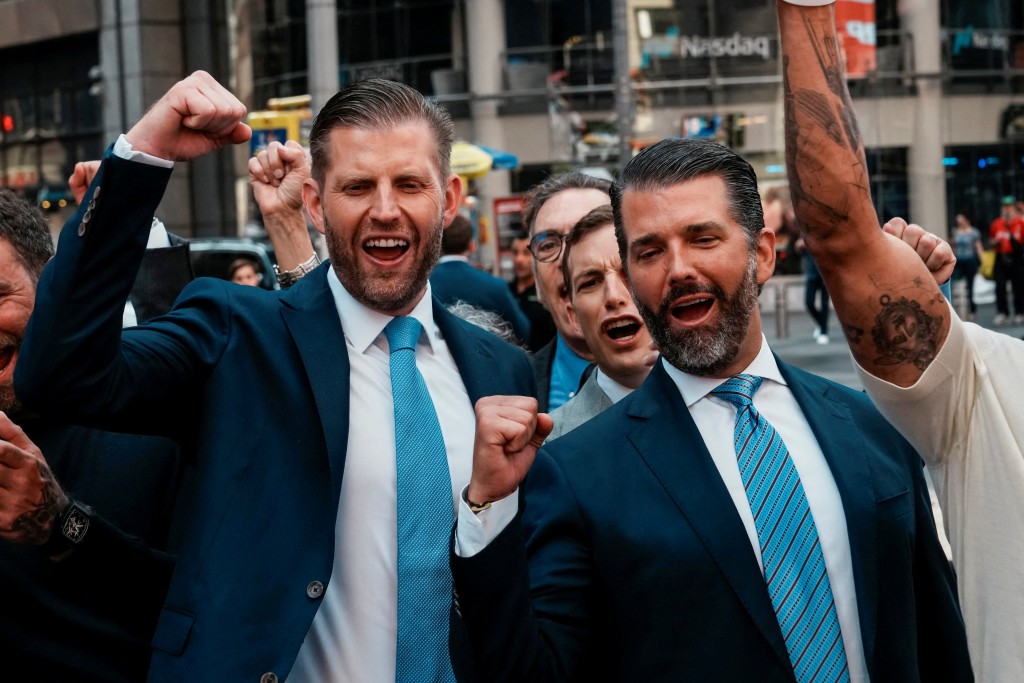 Donald Trump Jr., Eric Trump and Zach Witkoff, Co-Founder and CEO of World Liberty Financial, react outside the Nasdaq building after ringing the opening bell to celebrate the closing of $1.5 billion offering and adoption of its WLFI Treasury Strategy at the Nasdaq Market, in New York City, U.S., August 13, 2025.  REUTERS