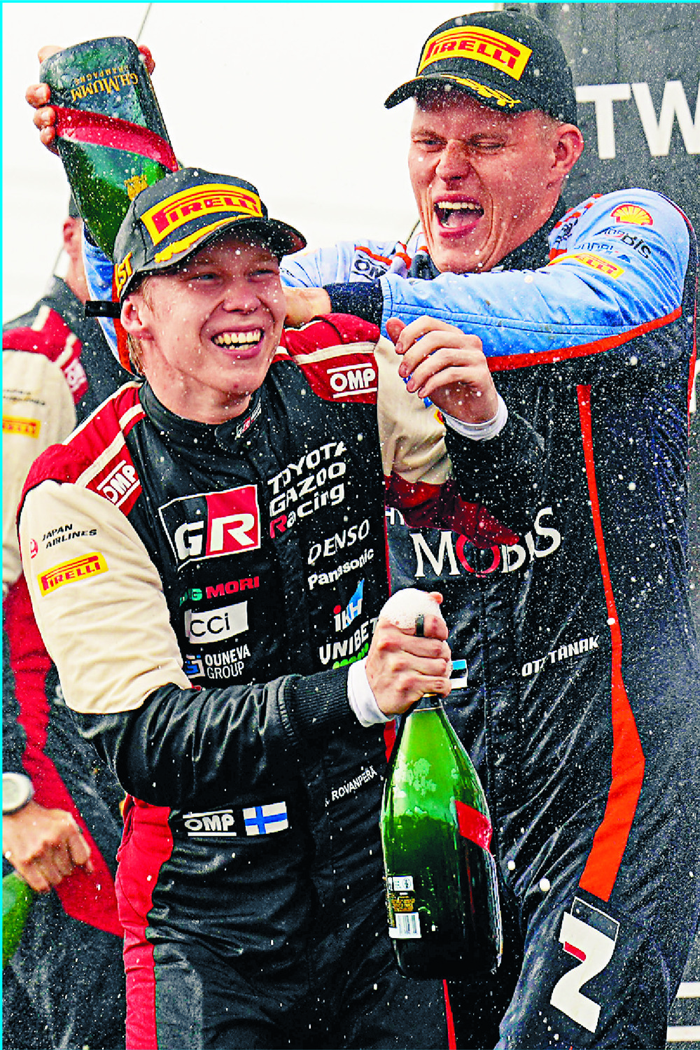 Kalle Rovanpera is showered with champagne by Estonian rival Ott Tanak on the podium at the Rally New Zealand. AFP Kalle Rovanpera is showered with champagne by Estonian rival Ott Tanak on the podium at the Rally New Zealand. AFP