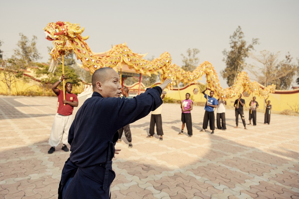 Photo by GIANLUIGI GUERCIA / AFP  Shaolin Monk Yan Zhen gestures during a training session of Dragon dance at a Shaolin Temple outside Lusaka, on August 8, 2026.