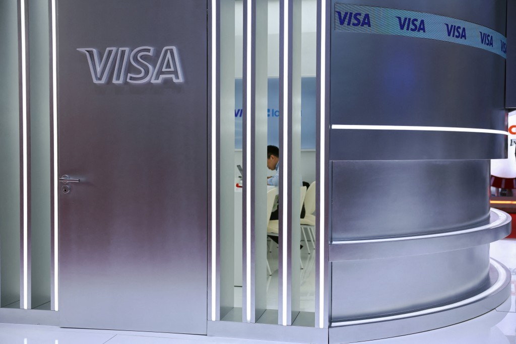 A man sits in a room at the Visa booth during the China International Supply Chain Expo (CISCE) in Beijing, China June 22, 2026. REUTERS