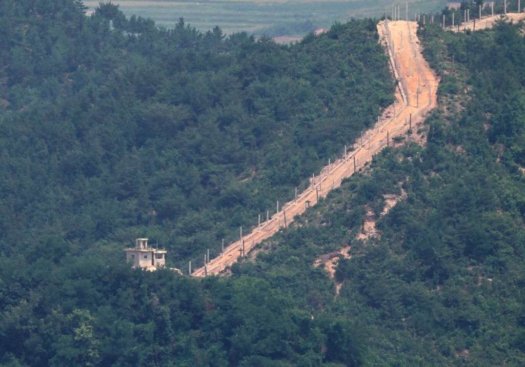 Photo by JUNG YEON-JE / AFP  A general view shows a North Korean guard post and military fences in North Korea's border county of Gaepung on the North Korean side of the Demilitarised Zone (DMZ), as seen from a South Korean observation deck at Aegibong Peace Ecopark in Gimpo on July 1, 2026.
