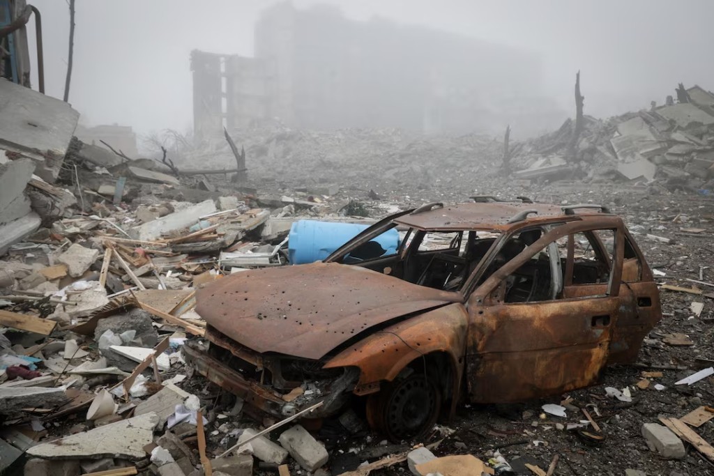 A destroyed car lies near apartment buildings damaged by Russian military strike, amid Russia's attack on Ukraine, in the frontline town of Kostiantynivka in Donetsk region, Ukraine November 28, 2025. Oleg Petrasiuk/Press Service of the 24th King Danylo Separate Mechanized Brigade of the Ukrainian Armed Forces/Handout via REUTERS