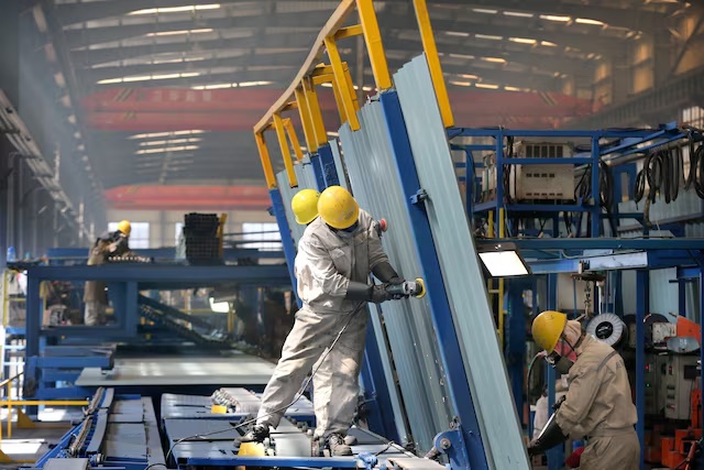 People work inside a factory of a shipbuilding industrial park at a port in Qidong city of Nantong, Jiangsu province, China March 16, 2020. China Daily via REUTERS 