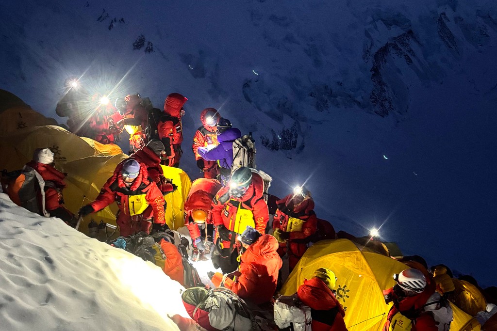 Photo by FURTE SHERPA / AFP This photograph taken on May 19, 2026, shows mountaineers leaving from Camp 3 to continue their ascent to summit Mount Everest in Nepal.