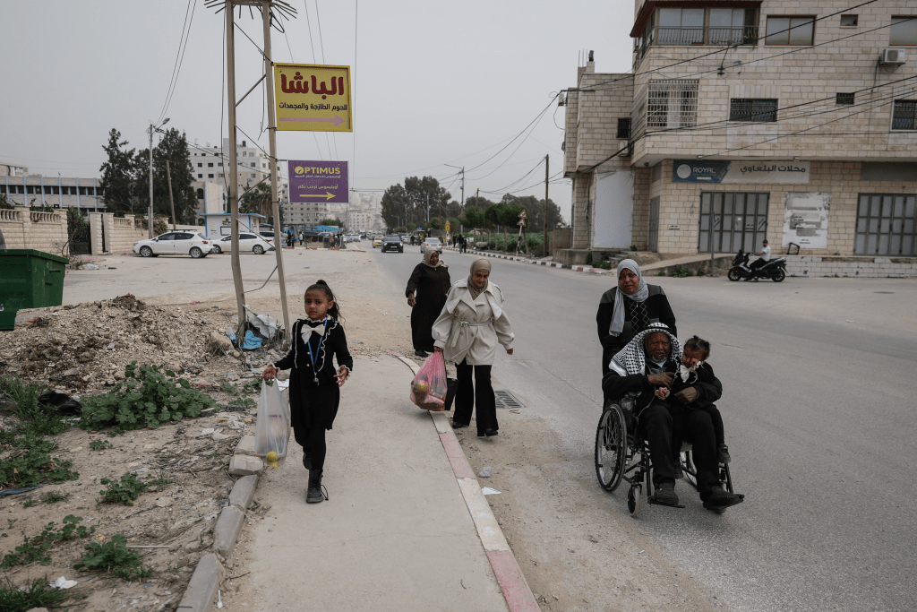 Members of the Ghanem family walk in Tulkarm in the Israeli‑occupied West Bank, Feb. 13, 2026. REUTERS/Ammar Awad
