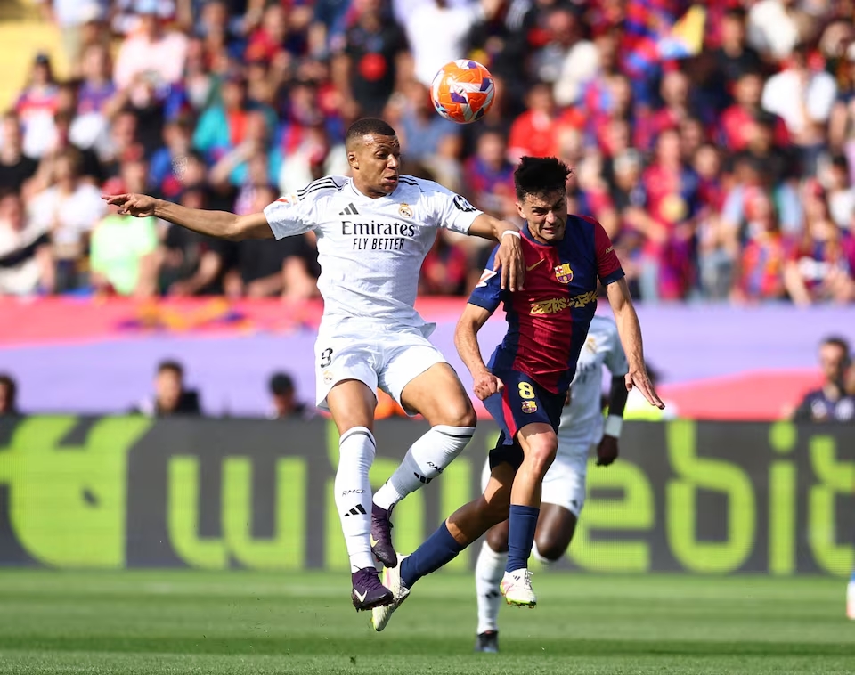 Real Madrid's Kylian Mbappe in action with FC Barcelona's Pedri. (Reuters)