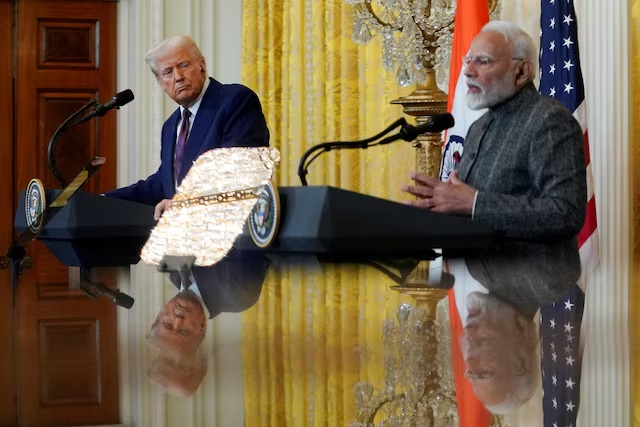 U.S. President Donald Trump and Indian Prime Minister Narendra Modi are pictured in a mirror as they attend a joint press conference at the White House in Washington, D.C., U.S., February 13, 2025. REUTERS/Nathan Howard/File Photo
