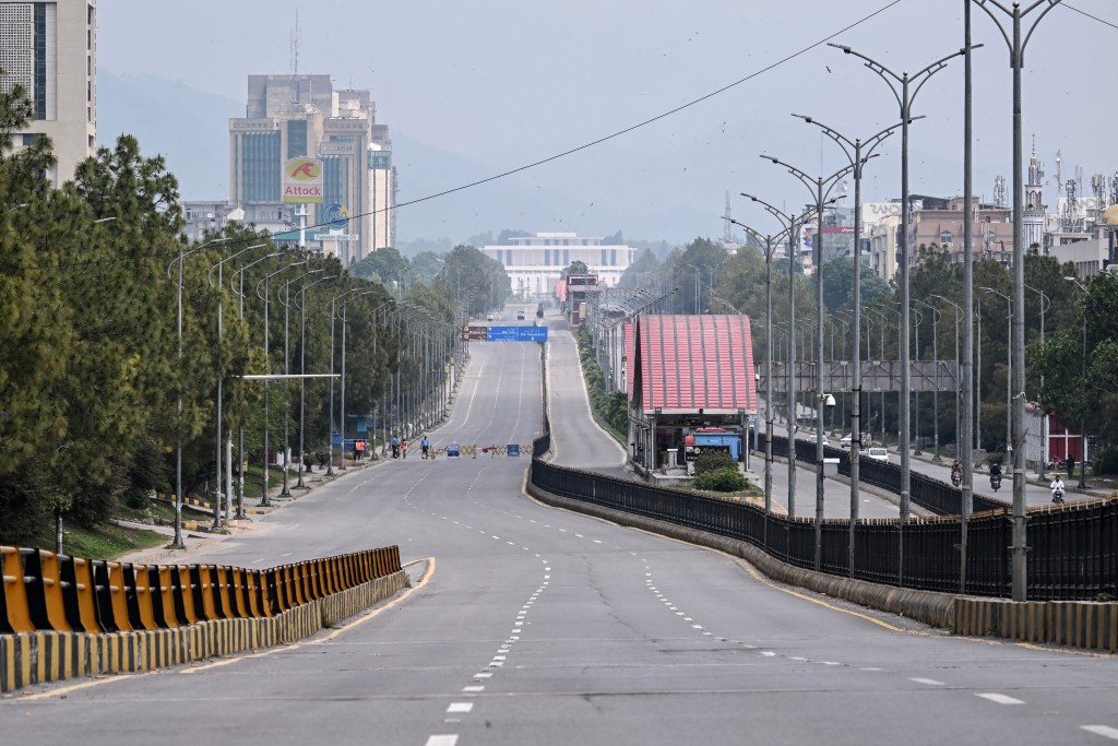 Photo by FAROOQ NAEEM / AFP. A deserted road leading to the Red Zone area is pictured after authorities restricted movement ahead of US-Iran peace talks in Islamabad on April 11, 2026.