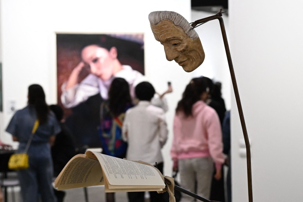 Visitors look at artwork by British artist Simon Starling called "Mask" on display at the Art Basel international art fair in Hong Kong on March 27, 2026. (Photo by Peter PARKS / AFP)