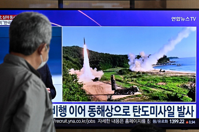 A man watches a news broadcast showing file footage of a North Korean missile test, at a railway station in Seoul on October 14, 2022. (AFP) A man watches a news broadcast showing file footage of a North Korean missile test, at a railway station in Seoul on October 14, 2022. (AFP)