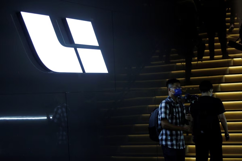 People stand near the logo of Chinese electric vehicle (EV) maker Li Auto at a product launch event in Beijing, China May 25, 2021. REUTERS