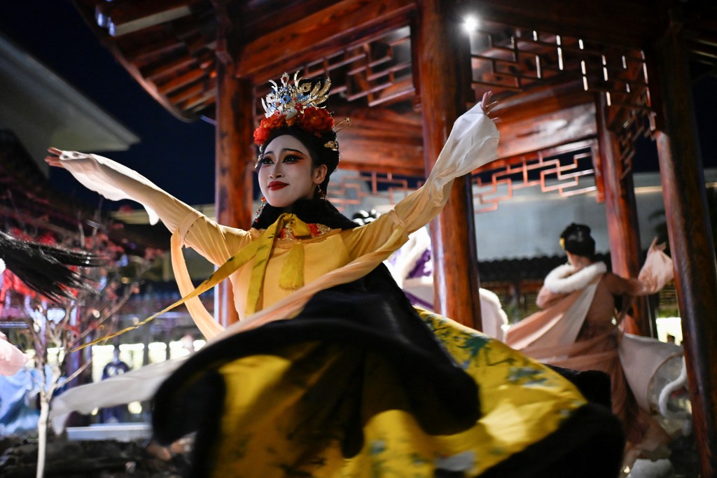 Photo by WANG ZHAO / AFP  This picture taken on November 2, 2025 shows artists in traditional Chinese clothes performing at a theatrical restaurant in Beijing.