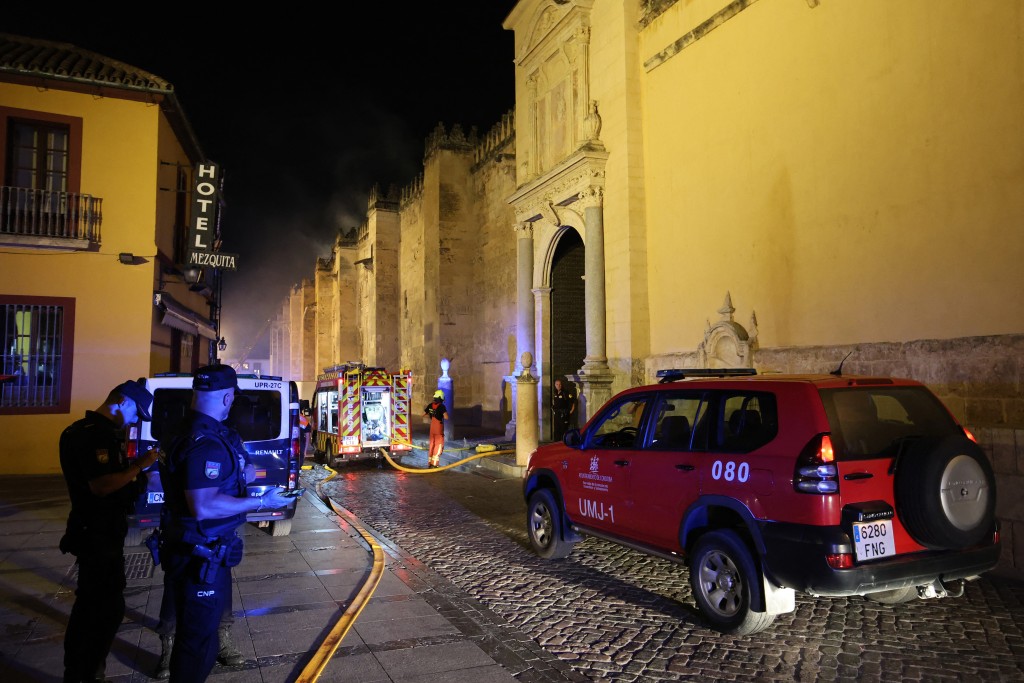 Firefighters work to extinguish a fire which broke out in the historic mosque-turned-cathedral in the southern Spanish city of Cordoba on August 8, 2025. (Photo by Madero CUBERO / AFP)