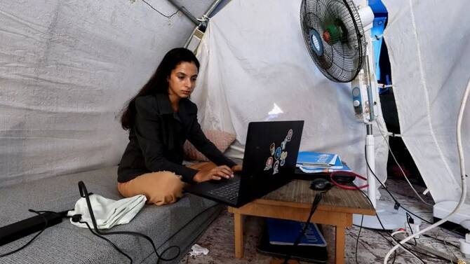 Palestinian student Raghad Mhanna recently celebrated passing her high school exams from a displacement camp in Deir Al-Balah, Gaza. (Reuters)