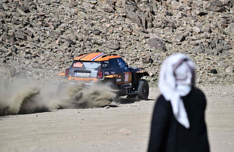 A local watches X-Raid Team driver Guillaume de Mevius and Mathieu Baumel compete in the prologue. AFP