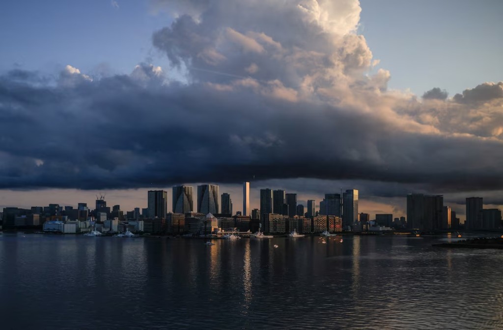 City skyline and harbour are seen at sunrise from a bus window in Tokyo, Japan July 24, 2021. REUTERS