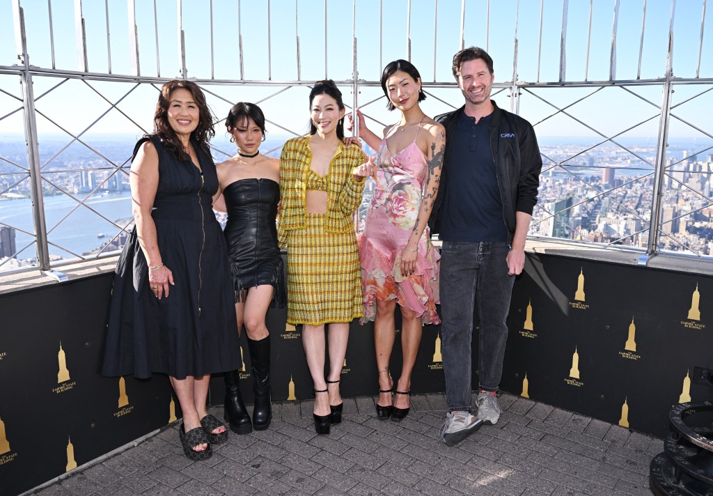 Rei Ami, Arden Cho and May Hong pose with guests as the light the Empire State Building to Kick Off KPOP DEMON HUNTERS Golden Weekend at The Empire State Building on August 22, 2025 in New York City. Roy Rochlin/Getty Images for Empire State Realty Trust/AFP (Photo by Roy Rochlin / GETTY IMAGES NORTH AMERICA / Getty Images via AFP)