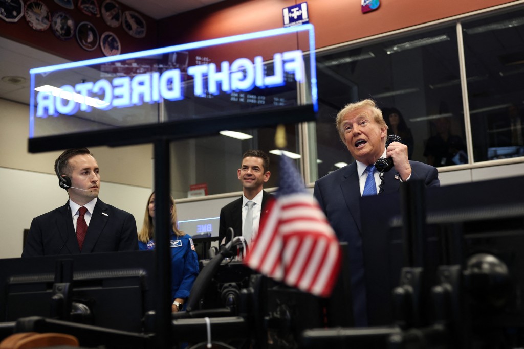 U.S. President Donald Trump (R) speaks to astronauts aboard the International Space Station alongside National Aeronautics and Space Administration (NASA) Administrator Jared Isaacman (3rd-L) at NASA Mission Control Center​ following a ceremony honoring Artemis II crew members at Johnson Space Center on August 28 (AFP)