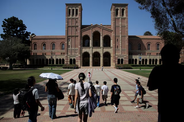 People walk through the campus of the University of California Los Angeles (UCLA) in Los Angeles, California, U.S., August 11, 2025. REUTERS/Daniel Cole/File Photo 