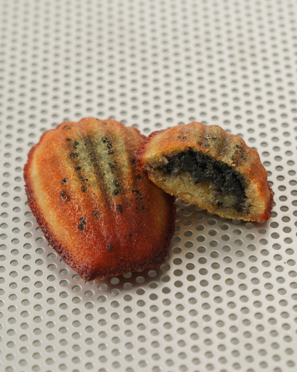 The Dark Secret — MADÉ’s signature madeleine is filled with an intense roasted black sesame and white chocolate core for a rich, nutty center.