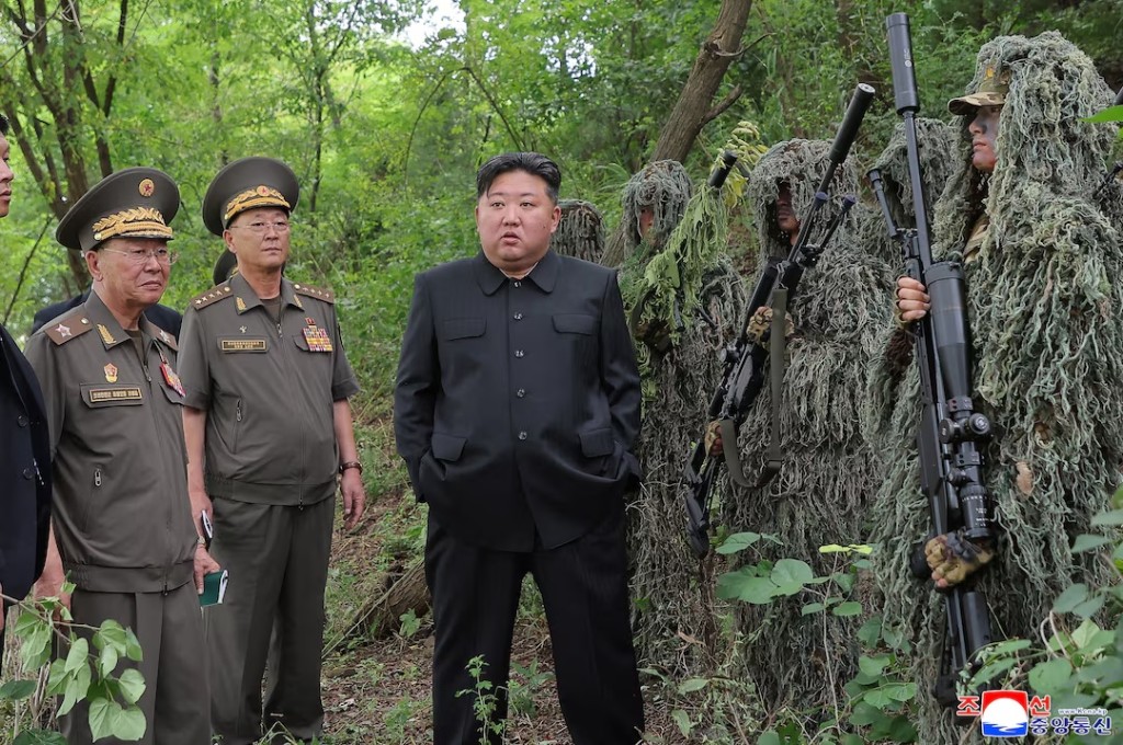 North Korean leader Kim Jong Un stands next to snipers during a visit to a special operation training base at an undisclosed location in this undated picture released by North Korea's official Korean Central News Agency August 28, 2025. KCNA via REUTERS