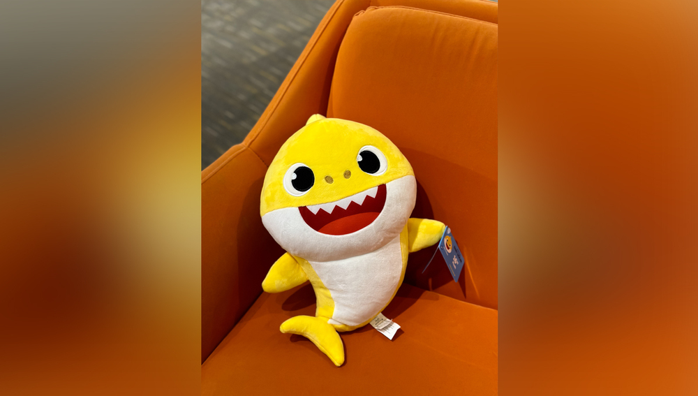 Grabbing the limited edition Baby Shark plush toy from the 3-meter-tall giant claw machine.