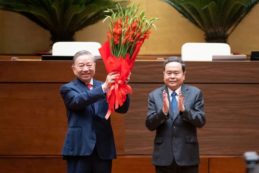Vietnam's Communist Party General Secretary To Lam receives a bouquet from National Assembly Chairman Tran Thanh Man after taking his oath as Vietnam's President in Hanoi, Vietnam, April 7, 2026. National Assembly Handout via REUTERS