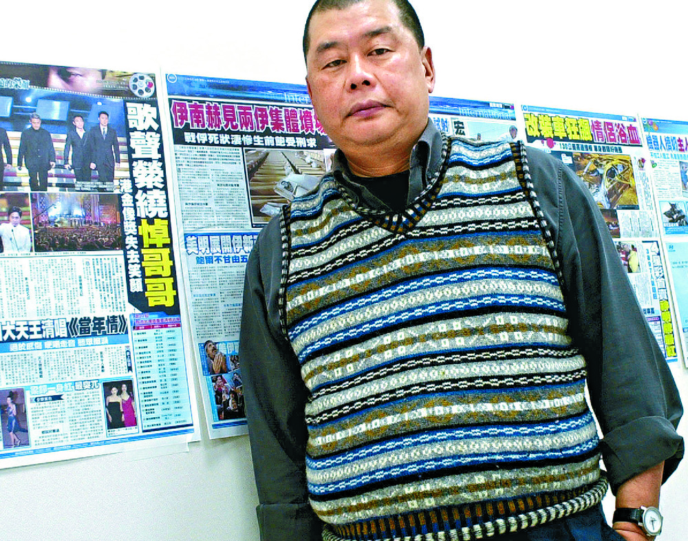 Jimmy Lai in Taipei with pages from a Taiwan Apple Daily dry run ahead of its 2003 launch. AP Jimmy Lai in Taipei with pages from a Taiwan Apple Daily dry run ahead of its 2003 launch. AP