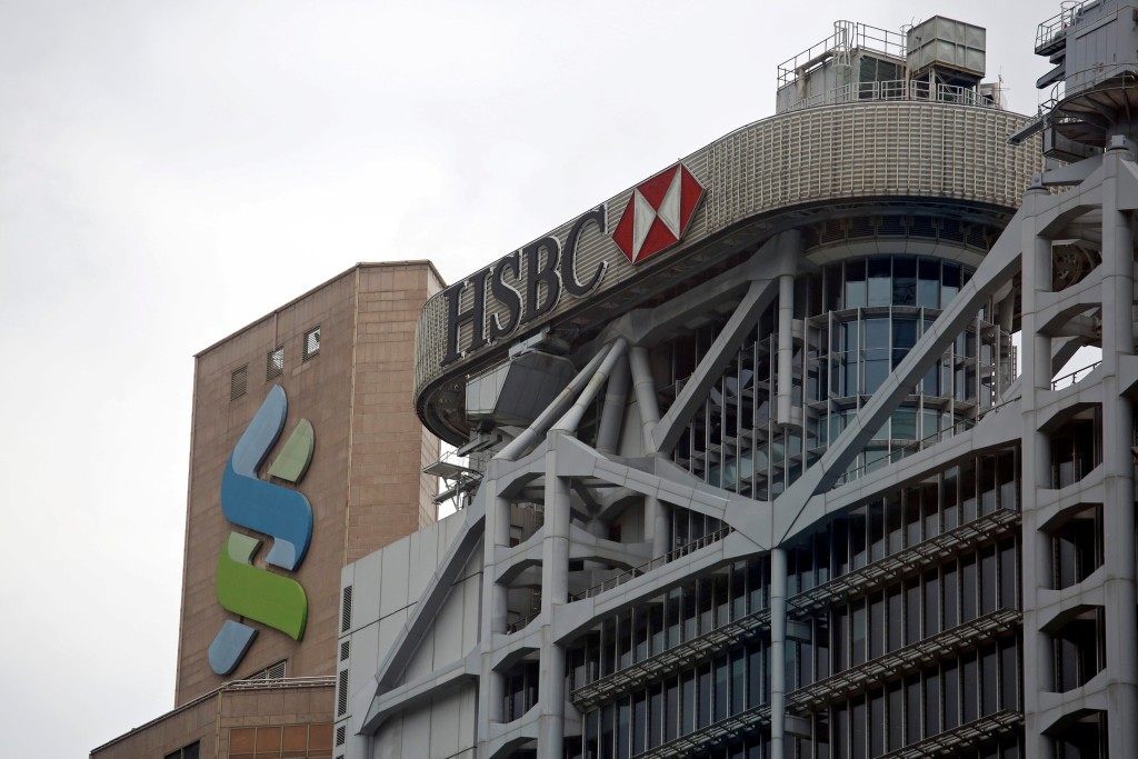 Logos of HSBC and Standard Chartered banks are seen at their headquarters in Hong Kong, China September 5, 2017. REUTERS