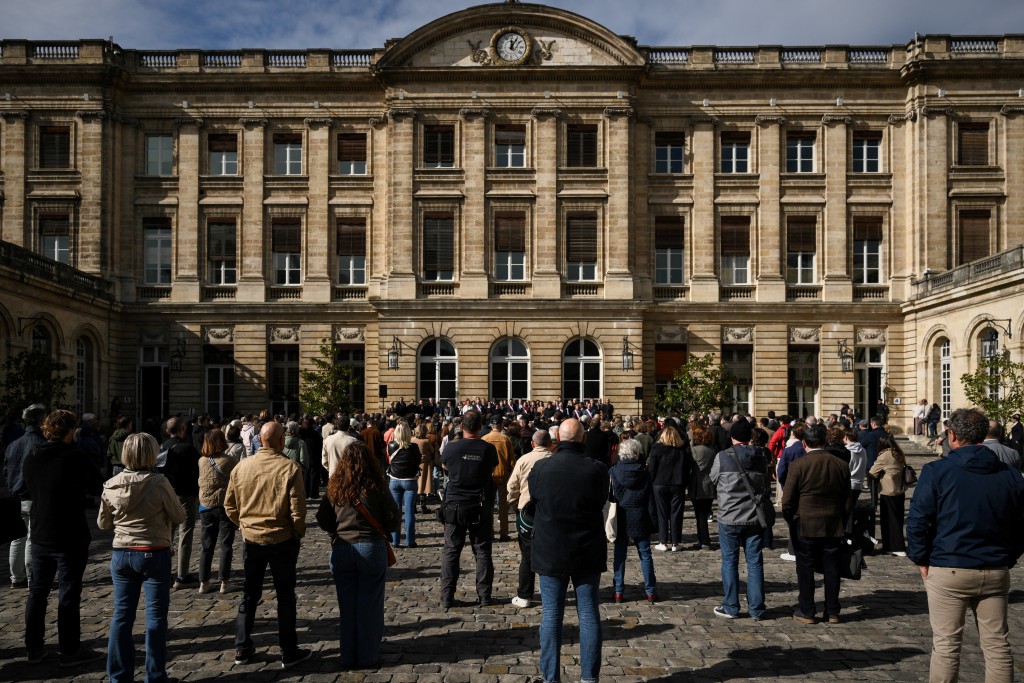 People stand in the courtyard of the city hall during a “republican rally” called by the mayor, in Bordeaux, south-western France, on October 19, 2026, two days after riots and looting occurred on the sidelines of nationwide cost-of-living demonstrations. (Photo by Philippe LOPEZ / AFP)