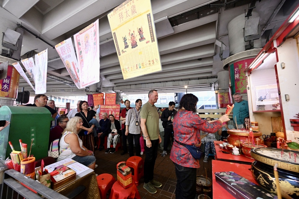 Tourists get a kick out of the villain-hitting ritual in Causeway Bay. Tourists get a kick out of the villain-hitting ritual in Causeway Bay.