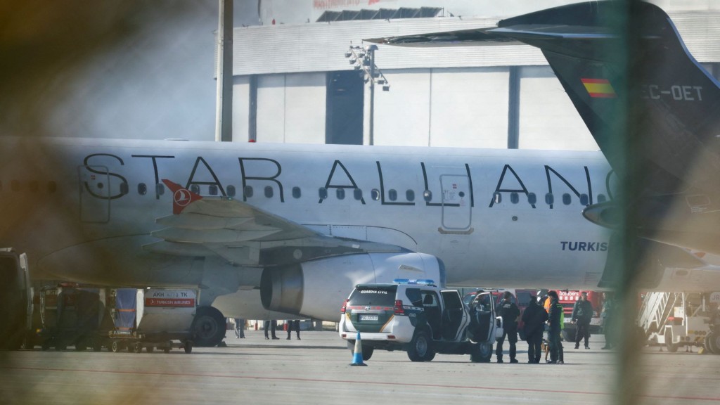 A Turkish Airlines plane is inspected by police after a false bomb threat. Reuters