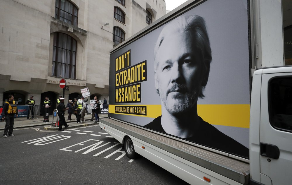 A van with a protest poster passes the Central Criminal Court Old Bailey in London, Monday. A van with a protest poster passes the Central Criminal Court Old Bailey in London, Monday.