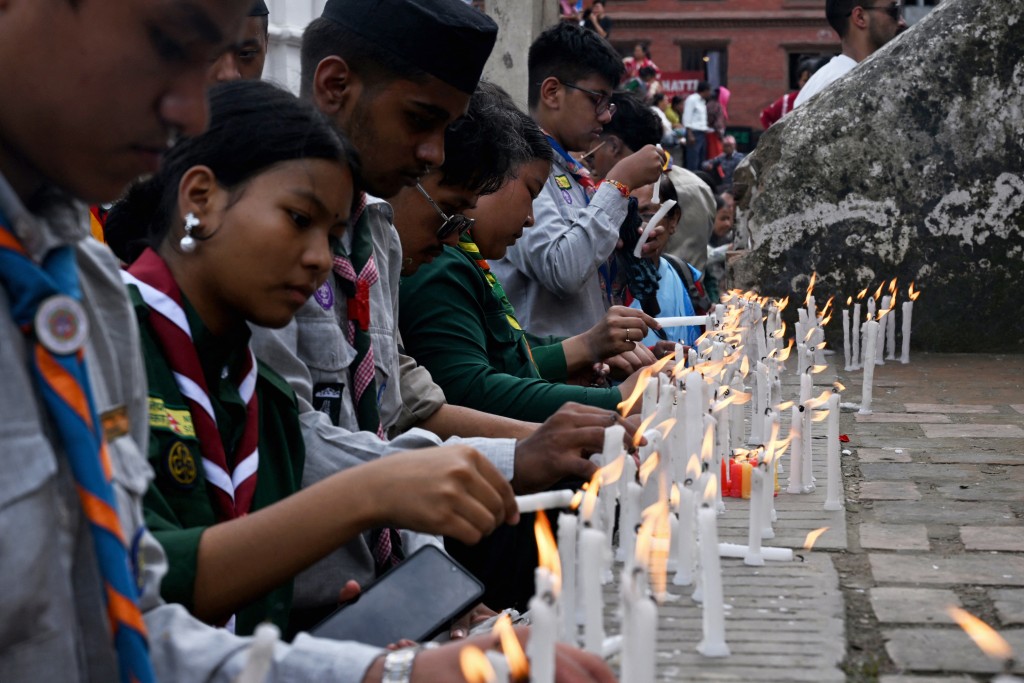 Nepali scouts light candles for flood victims during a vigil in Kathmandu on August 29, 2026. (AFP)