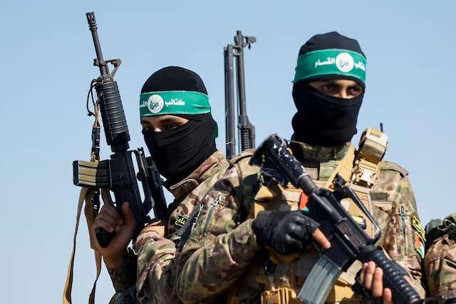 Palestinian fighters from the armed wing of Hamas take part in a military parade to mark the anniversary of the 2014 war with Israel, near the border in the central Gaza Strip, July 19, 2023. REUTERS/Ibraheem Abu Mustafa/File Photo 
