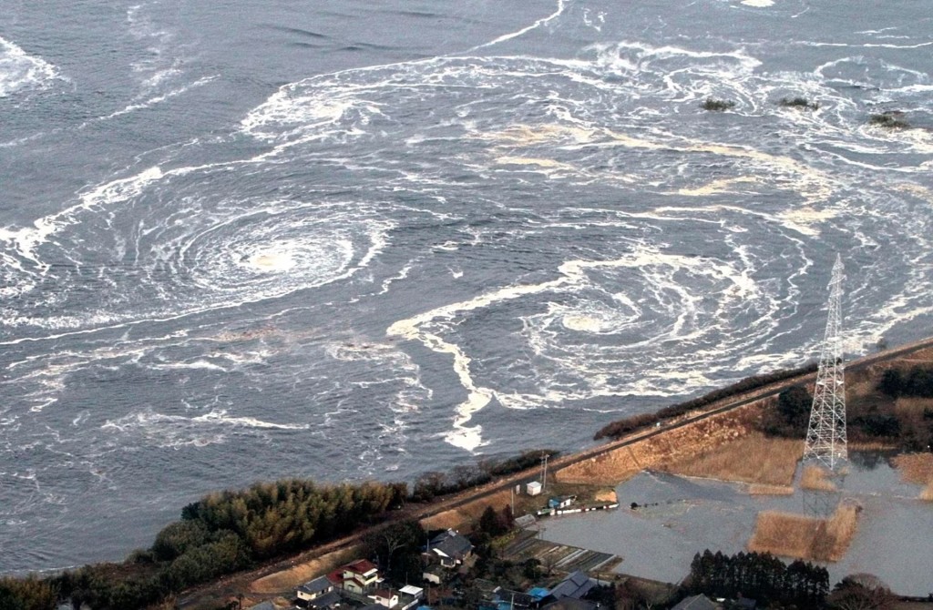 Whirlpools are seen following a tsunami and earthquake in Iwaki city, Fukushima Prefecture, March 11. REUTERS/Yomiuri