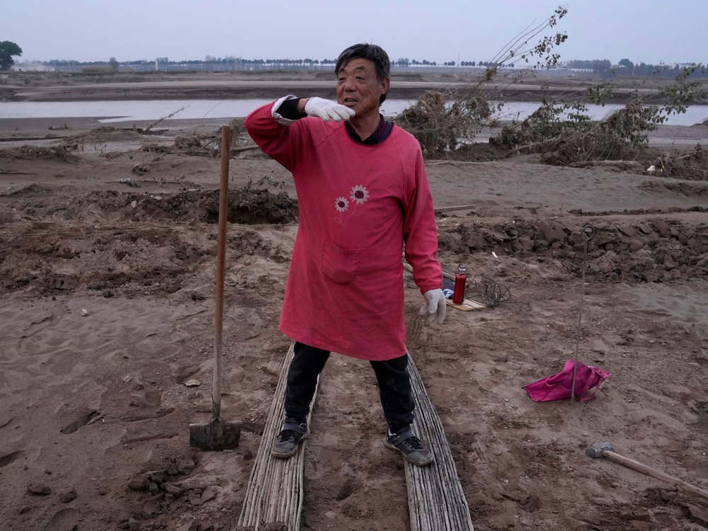 Wang Yuetang speaks about the flood that washed away his crops (AP Photo) Wang Yuetang speaks about the flood that washed away his crops (AP Photo)