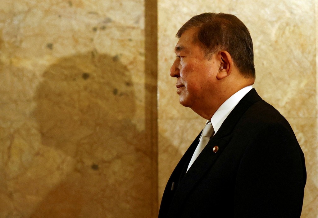 Japanese Prime Minister Shigeru Ishiba walks toward the upper house hall to attend an opening ceremony of parliament in Tokyo, Japan August 1, 2025. (Reuters)