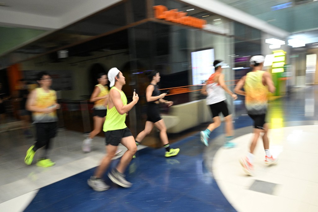 Photo by ROSLAN RAHMAN / AFP  Fitness enthusiasts run inside a mall due to haze situation outside in Singapore on October 24, 2026.